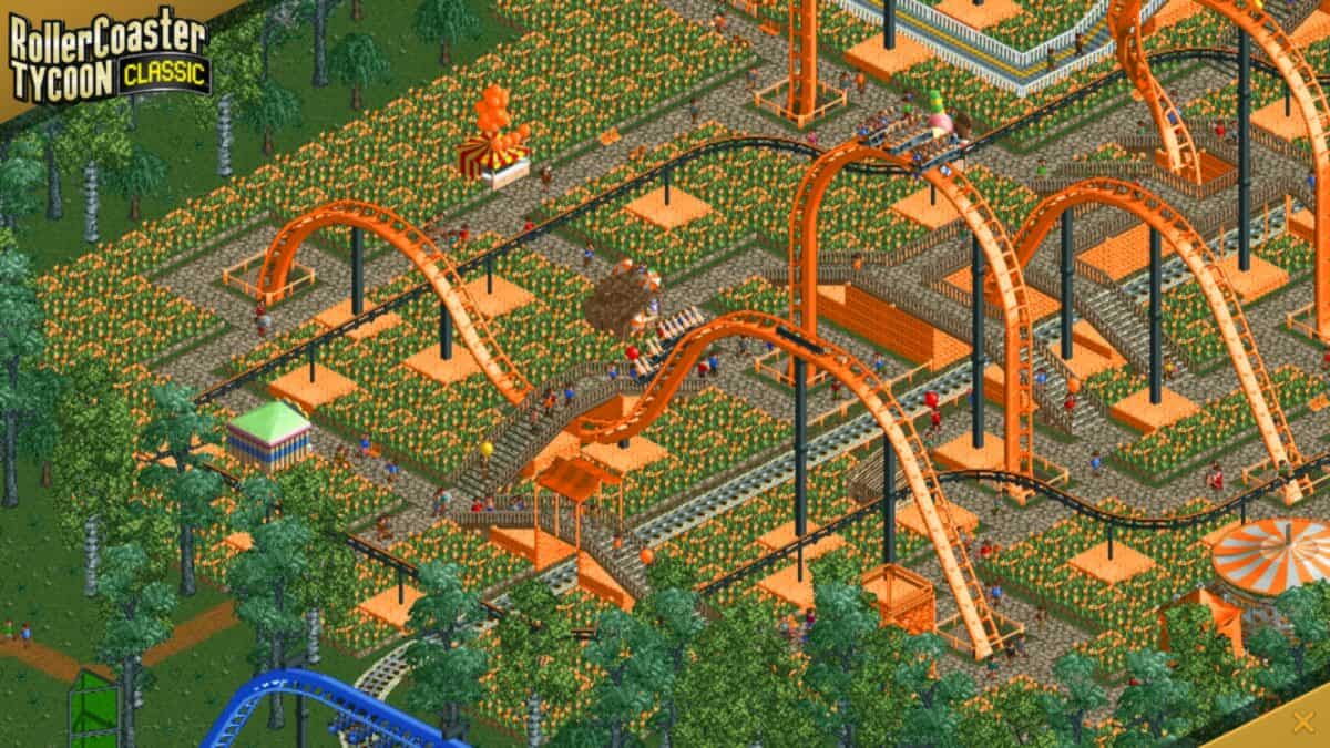 Screenshot from RollerCoaster Tycoon Classic showing an orange roller coaster with loops and guests walking in a theme park setting.