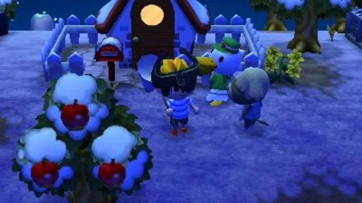 A player character talks to two animal villagers outside a house at night in a snowy Animal Crossing scene with an apple tree and yellow flowers.