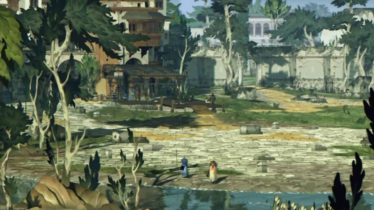 Two people stand by a riverbank in front of a stone-paved area, with buildings, trees, and ruins visible in the background under daylight.