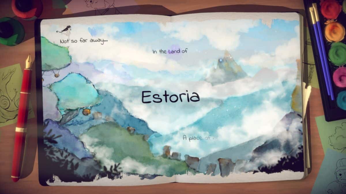 An illustrated storybook open to a watercolor scene of mountains and trees, with the text “In the land of Estoria” centered on the page. Art supplies are visible around the book.