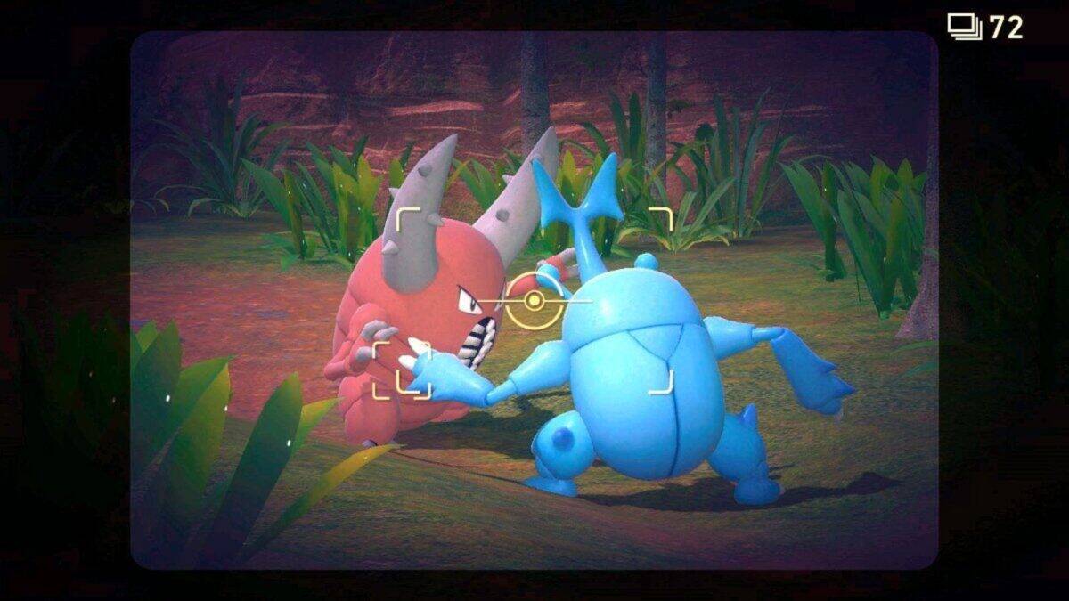 A red and a blue beetle-like creature are locked in a confrontation, captured through an in-game camera interface with foliage in the background.