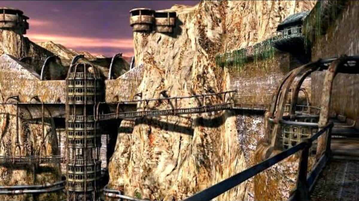 Steep rocky cliffs with metal walkways, towers, and suspended structures built into the rock face under a cloudy sky.