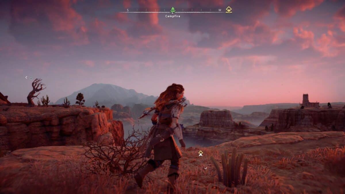 A character stands on a rocky cliff overlooking a canyon landscape at sunset, with distant mountains and ruins visible under a pink sky. Game interface elements appear at the top.