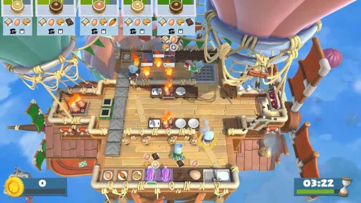 Overhead view of a chaotic kitchen on an airship in the game Overcooked 2, with food, fire, and multiple characters preparing dishes under a timer.