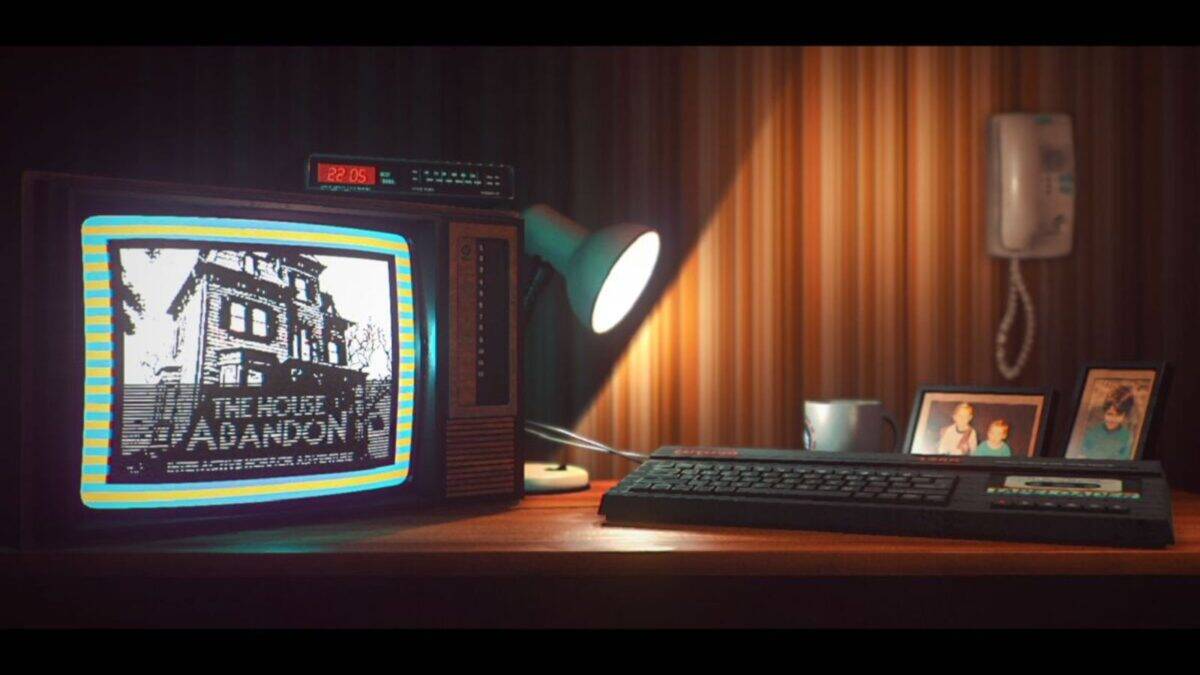 A retro desk with a CRT monitor displaying "The House of Abandon," a keyboard, desk lamp, wall phone, coffee mug, and framed family photos, against striped wallpaper.