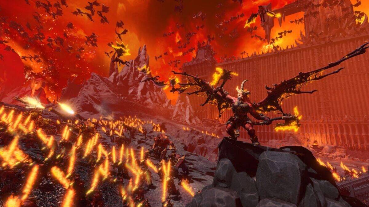A demonic winged creature stands on rocks in a fiery, hellish landscape with erupting flames, flying monsters, and a large fortified wall in the background.